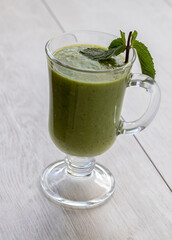 green wellness smoothie in a glass mug