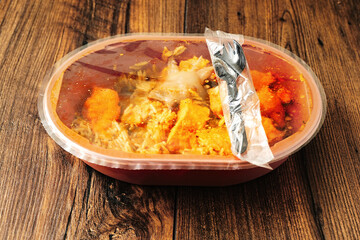 Chicken jalfrezi dish in a plastic bowl