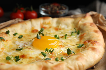 Fresh delicious Adjarian khachapuri with microgreens, closeup