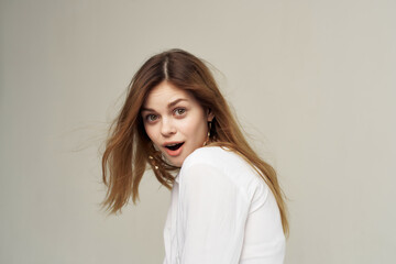 Naklejka premium attractive woman with earrings holding hair posing fashion