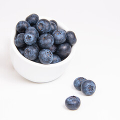 Fresh blueberry in white dish on the white background