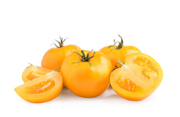 Cut and whole yellow tomatoes on white background
