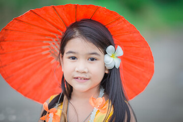 Close-up background view of a blurred Asian girl running or teasing in the street in front of the...