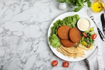 Delicious fried breaded cutlets with garnish served on white marble table, flat lay. Space for text