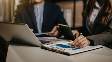 Businessman working as a team start meeting the new marketing project plan By business people using tablets and chart documents Calculate the amount of money for the project.