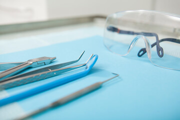 Close up cropped shot of dentists tools and eyeglasses