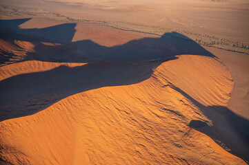 Fototapeta na wymiar Aerial images of arid regions in Africa, harsh desert environment. Popular tourist destination in Africa, the Namibian desert landscape.