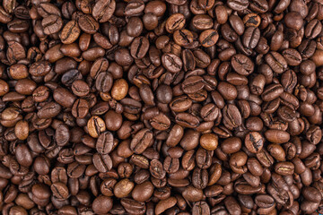 Fototapeta premium Roasted coffee beans on the table close-up. Texture. Background