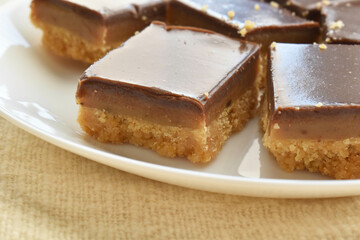 Millionaire's shortbread, caramel shortcake, or millionaire's slice on a white plate. 