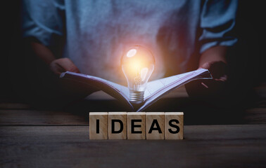 People reading books to create ideas for work.Concept of the idea of working sparking an idea.