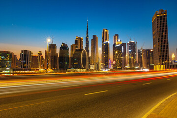 Fototapeta na wymiar Dubai, United Arab Emirates - August 13 2021: Beautiful view of Dubai city skyscrapers or skyline along with Burj khalifa captured from Marasi Drive at Business Bay District, Dubai, UAE.