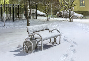 City streets and park after heavy snowfall at night.
