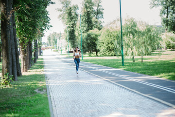 young woman on a morning jog in a city park.