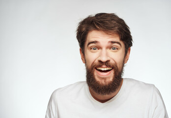 Obraz premium emotional man in a white t-shirt serious look close-up