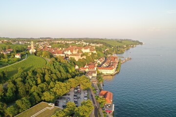 Wide Aerial Drone Shot of the City of Meersburg at Lake Constance, Germany while golden hour
