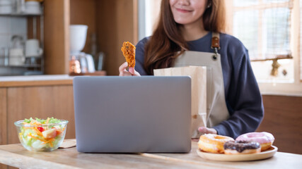 A female video blogger cooking, showing and filming food in the kitchen for online learning cooking class concept