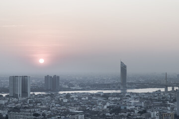 Aerial view of Amazing beautiful scenery view of Bangkok City skyline and skyscraper before sun setting creates relaxing feeling for the rest of the day. Evening time, Selective focus.