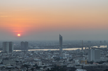 Naklejka premium Aerial view of Amazing beautiful scenery view of Bangkok City skyline and skyscraper before sun setting creates relaxing feeling for the rest of the day. Evening time, Selective focus.