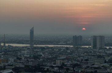Naklejka premium Aerial view of Amazing beautiful scenery view of Bangkok City skyline and skyscraper before sun setting creates relaxing feeling for the rest of the day. Evening time, Selective focus.