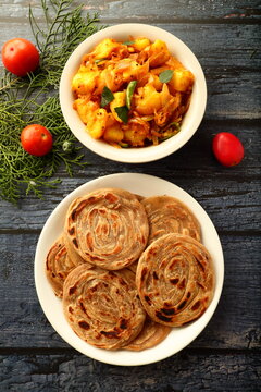 Indian vegan diet recipes- homemade wheat paratha served with potato curry roast.