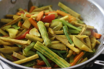 Chopped vegetables in the cooking pan while cooking for Aviyal, a popular kerala dish