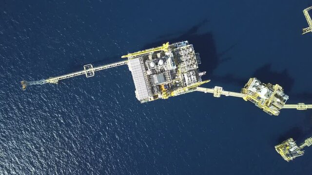 Central processing platform (cpp) in the middle of the ocean on sunny day - upstream industry
