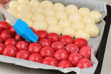 Chef Hand Brush the Dough Chigiri or Bubbles Bread, Pull Apart Hokkaido Soft Milk Bread. A Pan of Soft and Fluffy Japanese Bread with Bubbles Shape.