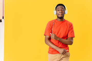 African American with headphones music entertainment yellow background lifestyle