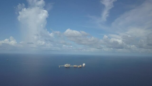Central processing platform (cpp) in the middle of the ocean on sunny day - upstream industry
