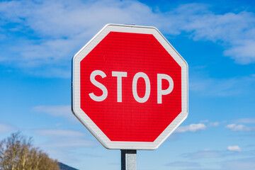 Stop sign with blue sky background.
