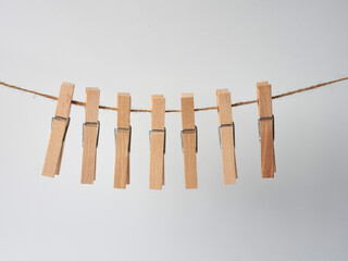 Set of wooden clothes pins on white background