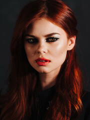 Fototapeta premium pretty red-haired woman bright makeup face close up studio