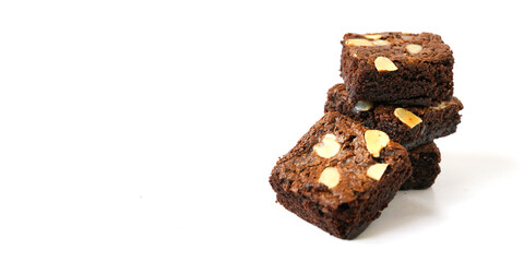pieces of fresh homemade chocolate brownie, square shape, with sliced almond on top isolated on...