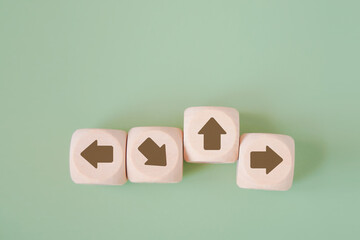 wooden cube with brown arrow pointing up, difference direction from the others for think different, individual unique, leading and standing out concept