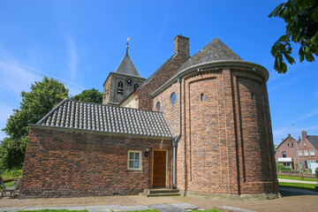 Obraz premium View on one of the oldest dutch romanesque protestant church from 10th century in the flood plains of rhine area against blue summer sky - Oude Kerk in Osterbeek - Wolfheeze, Gelderland, Netherlands