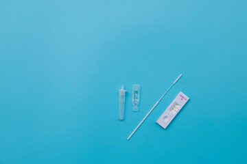 Rapid kits of Covid-19 Ag test seen on blue background.