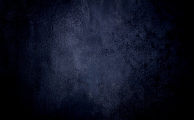Dark blue textured concrete background with center light spot . Abstract texture for graphic design or wallpaper