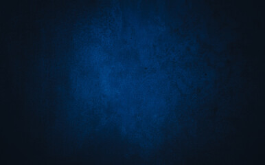 Dark blue textured concrete background with center light spot . Abstract texture for graphic design...