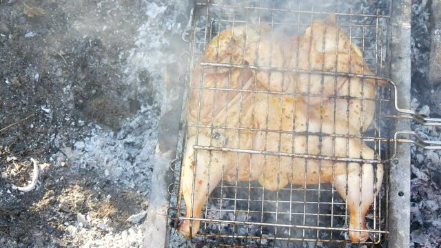 Whole juicy with spices grilled chicken tabaka or tapaka at summer picnic