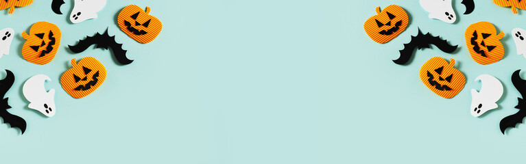 Halloween party concept with fun paper decor, pumpkins, ghost