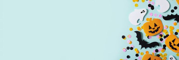 Halloween party concept with fun paper decor, pumpkins, ghost