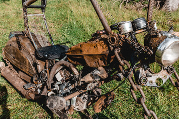 An old, rusty motorcycle, with bullet holes in it, post apocalyptic concept