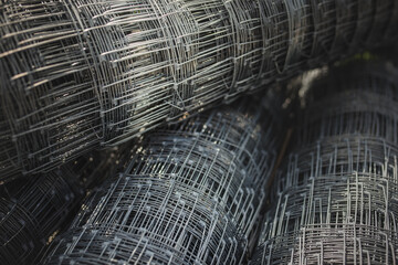 Close-up view of rolled fence mesh.