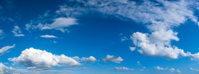 Panoramic photo of blue sky and white clouds. Beautiful wallpaper and background.