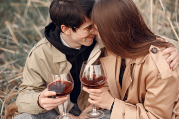Beautiful couple spend time in a autumn field