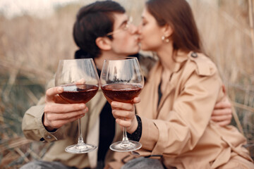 Beautiful couple spend time in a autumn field