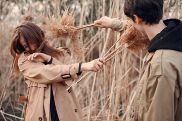 Beautiful couple spend time in a autumn field