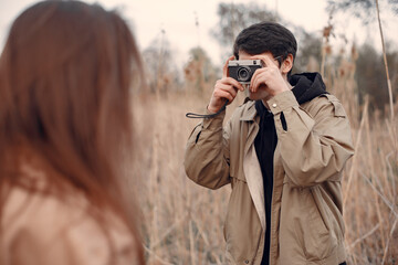 Beautiful couple spend time in a autumn field