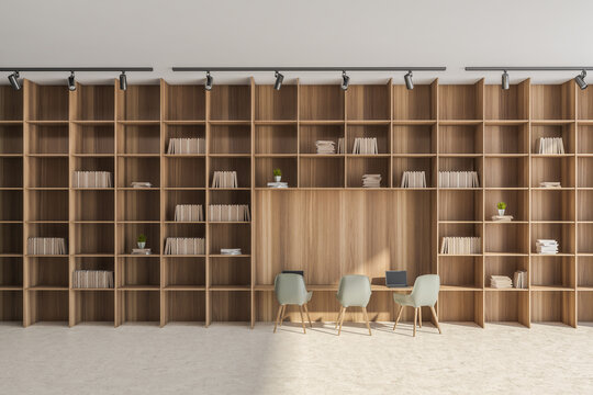 Office wall with beige and green details and floor-to-ceiling shelving