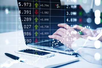 Businessman wearing white shirt is typing on laptop